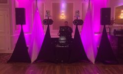 Our base DJ setup with our included lights. Here we just up-lit the DJ booth area and we can make that the color of your choice.